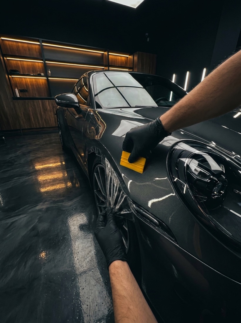 Paint protection film being applied to a sports car in Wollongong
